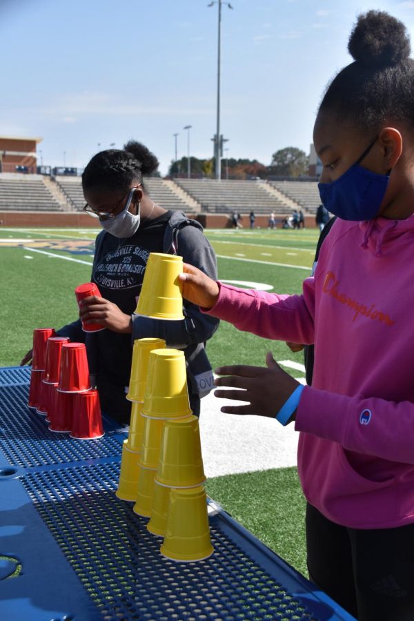 Two Viking students race each other in a cup stacking competition.