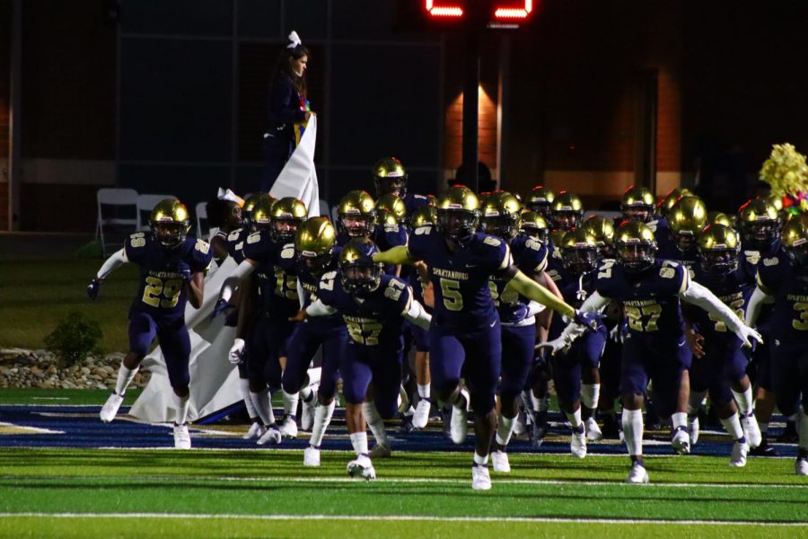 Running out of the tunnel, the Vikings get ready to kick off their game.