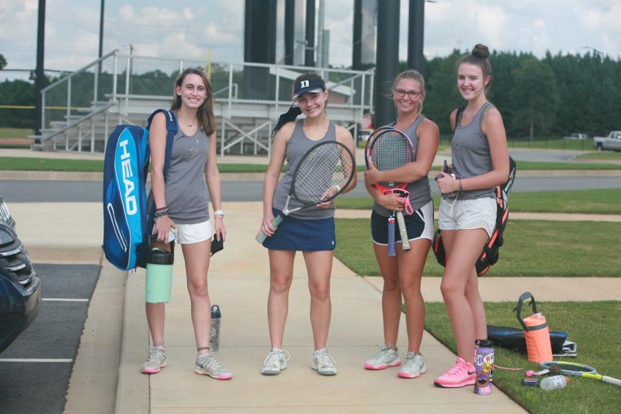 The+varsity+tennis+team+gathers+before+a+match+on+senior+night.+