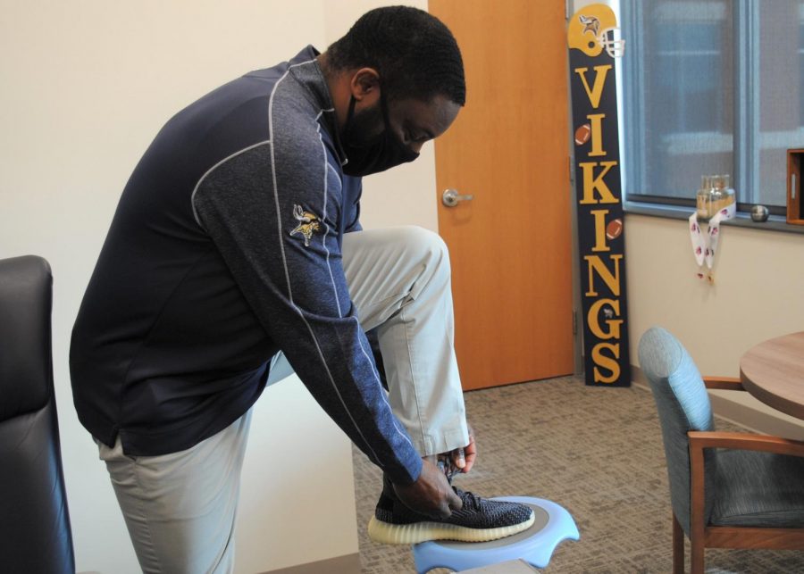 Lacing up his sneakers, Principal Vance Jones shows off a little piece of his expansive shoe collection.