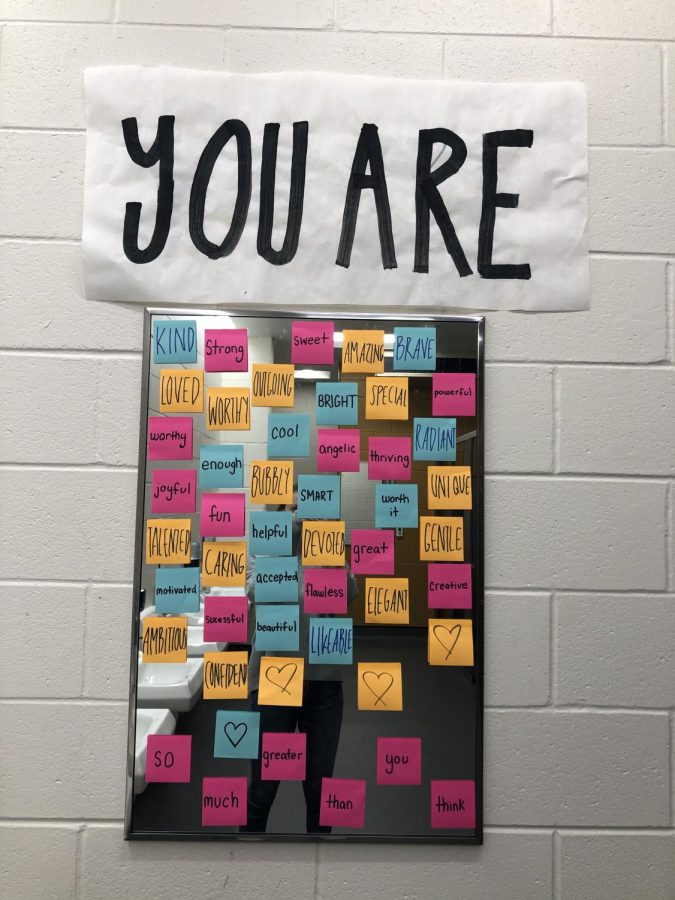 Positive messages written on sticky notes covered the girls' bathroom mirror during Kindness Month. 