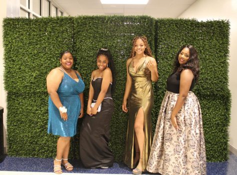 Students pose for a picture in their prom dresses before hitting the dance floor. 