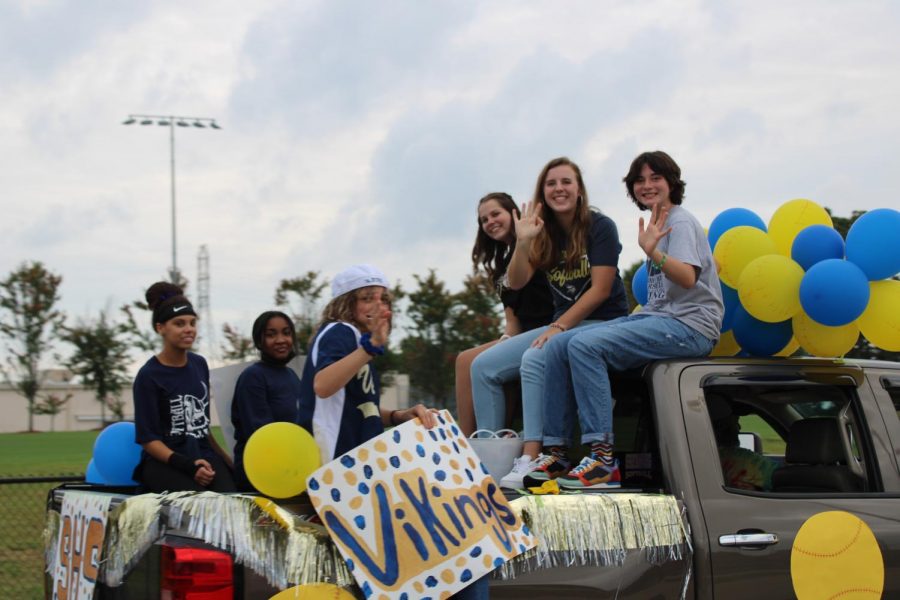Members of the softball team celebrate during the Homecoming parade.