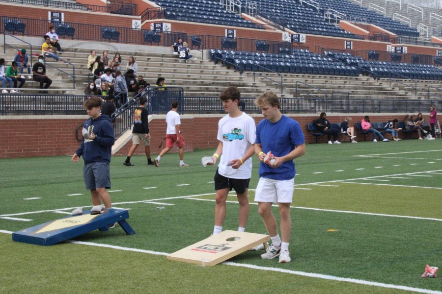 Luke Fisher (11) and John Mullen (11) work together to play a game of cornhole.