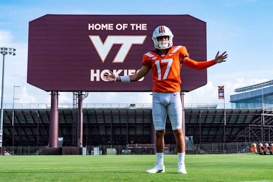 John Love (12) on his official visit tries on the pads and poses in front of the famous Lane Stadium.