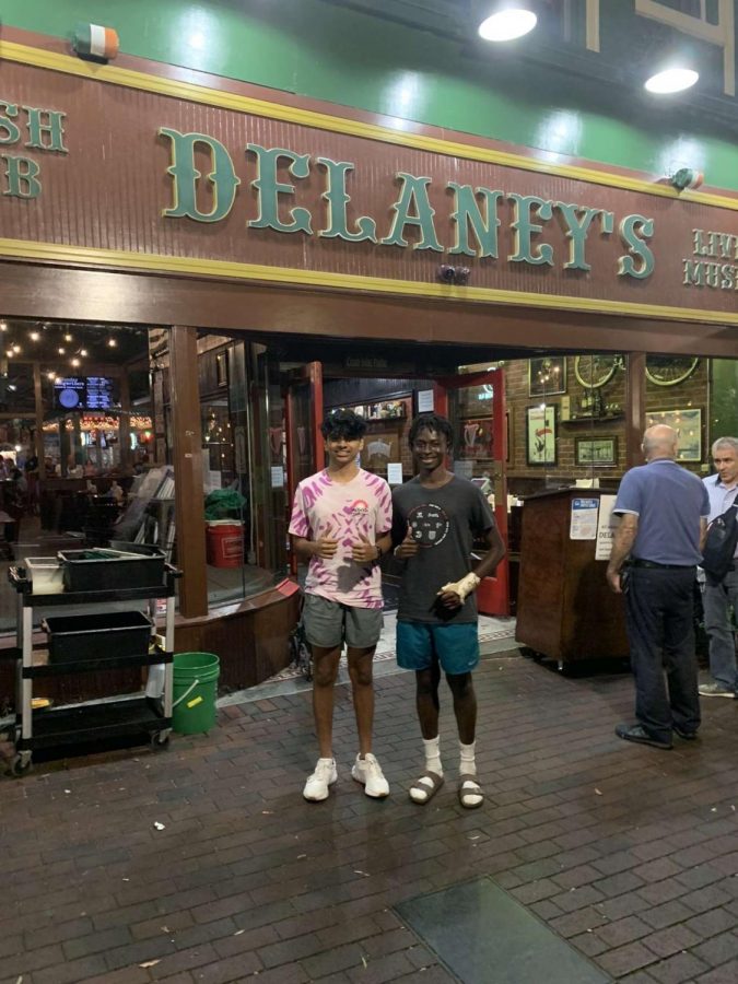 Dev Patel (11) and Lars Harris (11) pose at the entrance of Delaneys Irish Pub. 