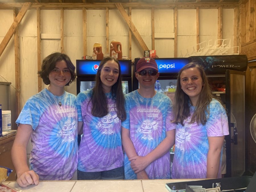 Ella Hammond (11), Savannah Fly (12), Daniel Johnson (11) and Anna Jakubchak (12) sport matching tie-dye shirts while working for the Spartanburgers.