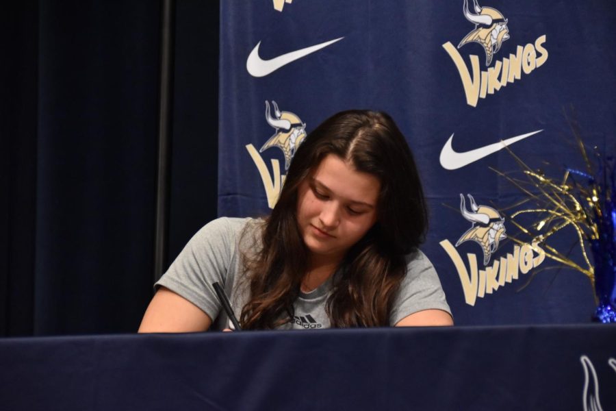 Kara Gilsdorf (12) signs to continue her athletic career at Montreat College.