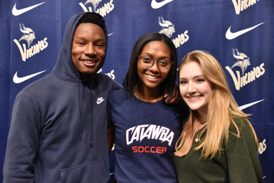 Cameron Hines (12) smiles with her friends, excited with her signing.