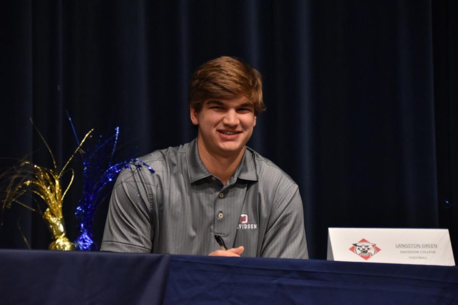 Langston Green (12) smiles after signing with Davidson College.