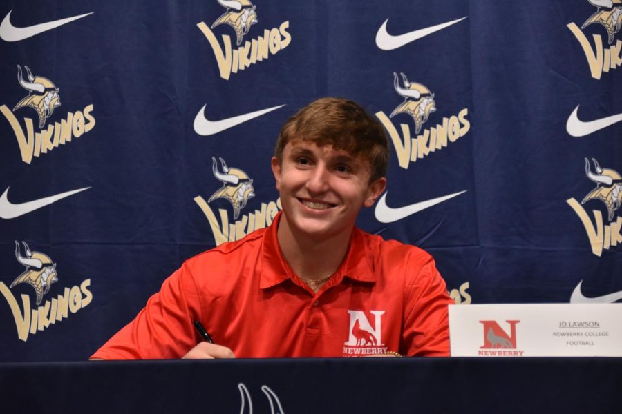 John David Lawson (12) smiles as he signs with Newberry.