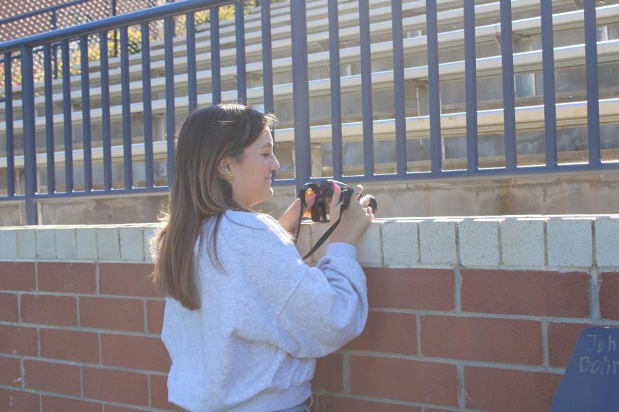 Eliza Petty (12) takes a photo for the photography staff to be published in the yearbook.