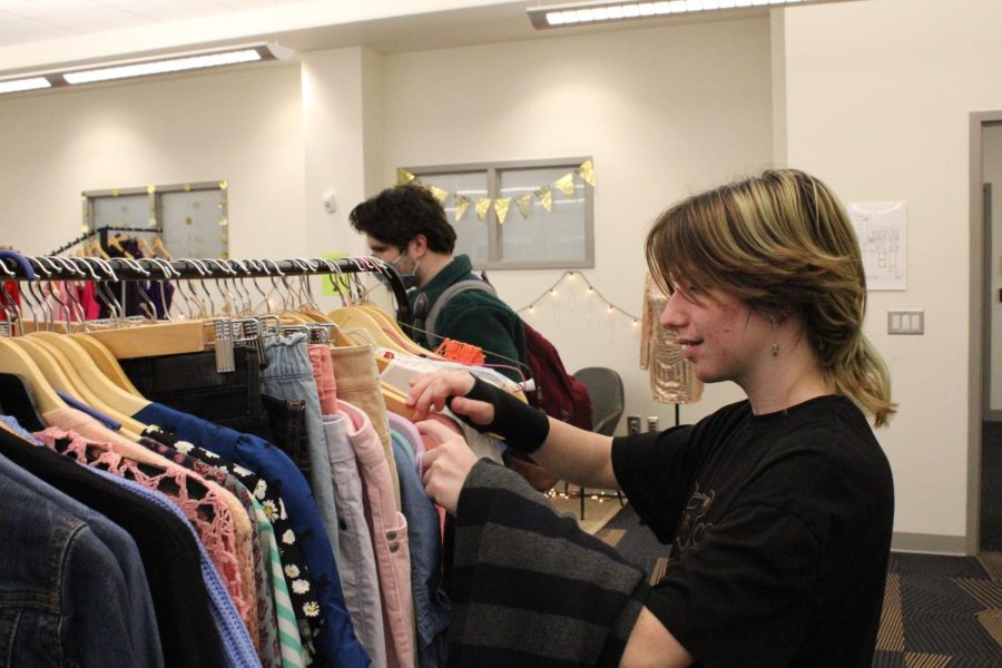 Julia Wilcox (11) and Simon Dingler (12) look around the new thrift store located in room 2219.