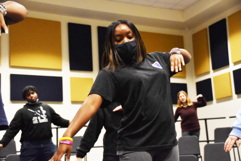 Erica Woods (12) practices choreography skills during the daily rehearsals.