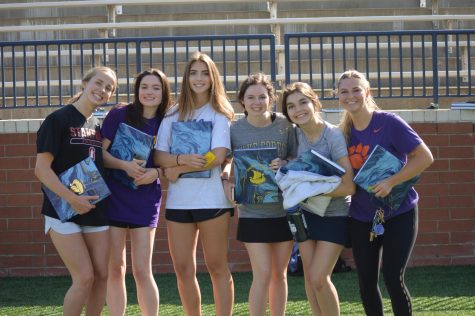 Posing with the Viking Voyage yearbook, Kirsti McEnroe (12), Elizabeth Skinner (12), Violette Franke (12), Sarah McMeekin (12), Sophie Butehorn (12), and Eliza Hull (12) cant wait to see whats inside.