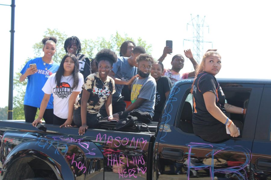 A car full of seniors comes down the drive during the Senior Parade.