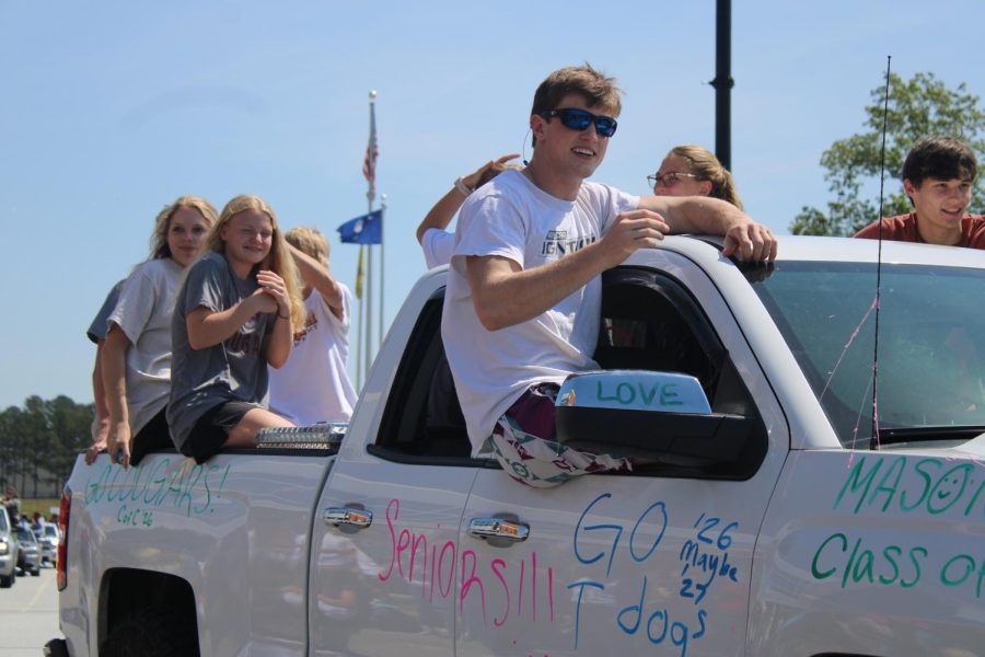 Seniors Banks Mullen, Lilly Byers, and others wave during the Senior Parade.