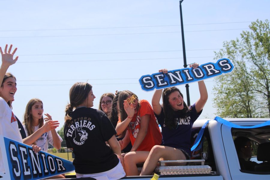 Seniors Annie Colbath, Mason Seegars, and others participate in the Senior Parade.