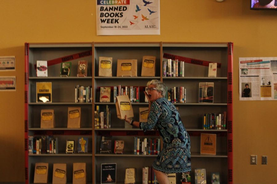 Librarian+Susan+Myers+shows+off+the+banned+books+display+in+the+library.