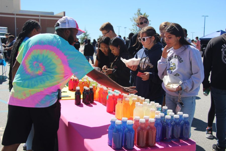 Karina Martinez (12) and Abigail Graham (12) enjoy time with friends while deciding on a colorful lemonade.