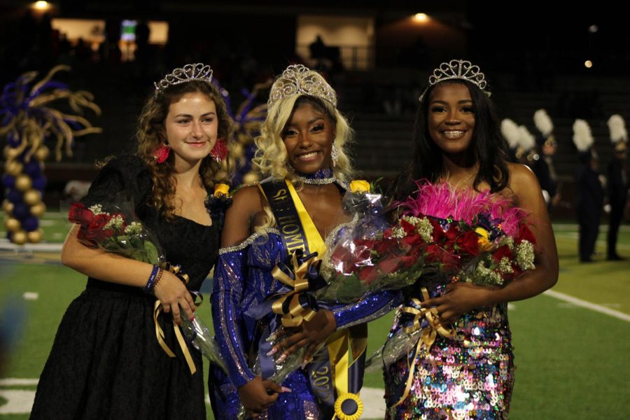 Honor attendants, Rookhie Sullivan (12) and Wesyleie Moss (12), smile alongside the newly-crowned SHS Homecoming Queen, Yaya Cheeks (12).