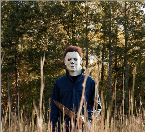 The Halloween sagas infamously masked villain, Michael Myers, stands in a field during one of his killing sprees.