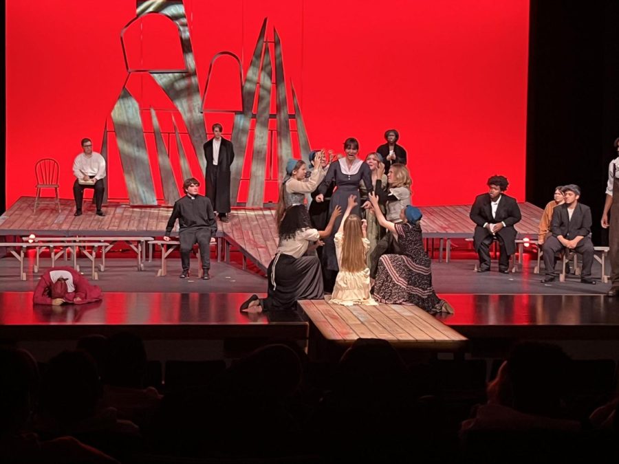 Stunning visuals and strong performances all around helped to bring The Crucible to life. The red backdrop in this scene portrayed the fear the actors were trying to deliver.