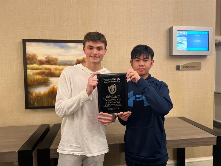 Brady Johnson and Daniel Lin with their third place plaque awarded to them for their violin duet performance.