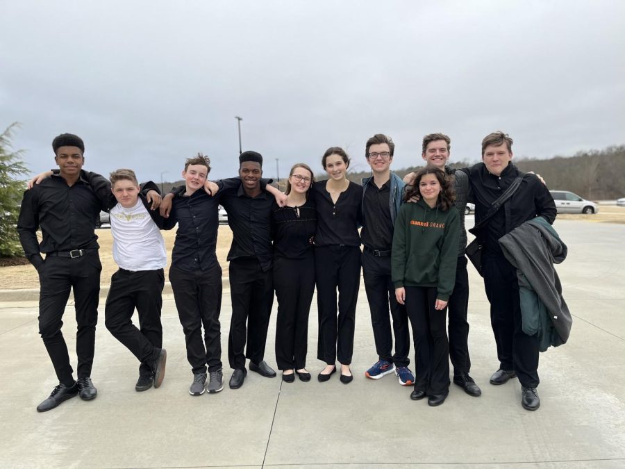 Members of the Percussion Ensemble pose for a picture after touring the District 7 elementary schools.