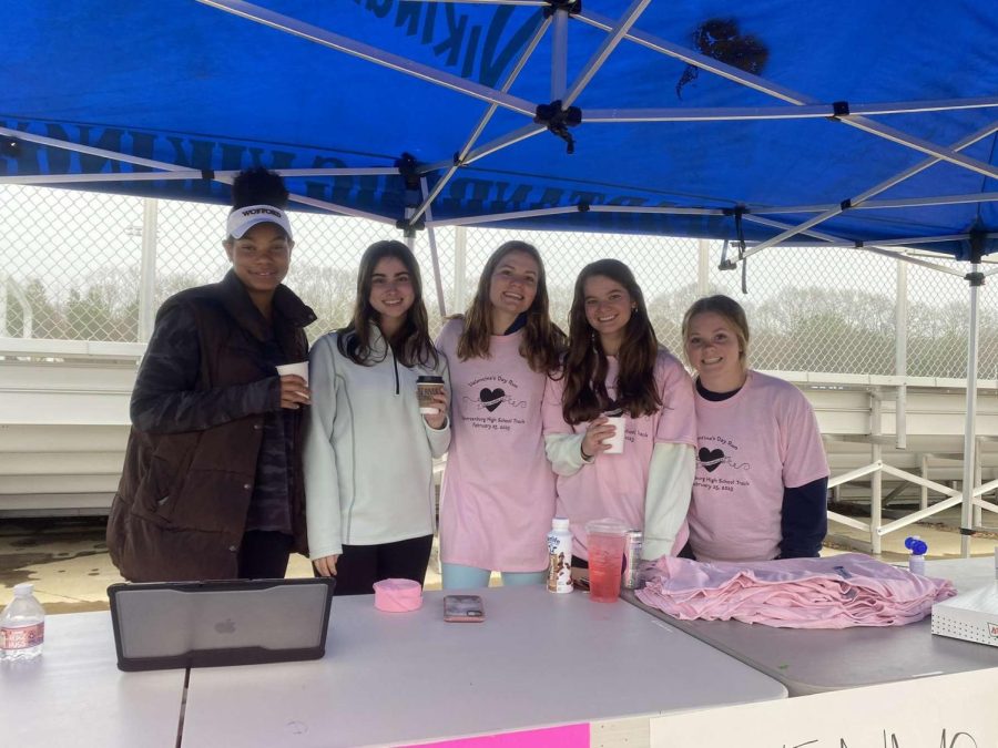 Caris Mitchell (12), Mary Jordan Jeneski (12), Dorothy Salley (11), Eliza Phillips (11) and Libby Cheek (11) sip coffee while helping runners and spectators. 