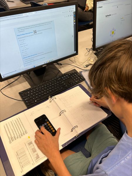 Chap Willbanks (10) uses his phone as a calculator as he works on his math homework.