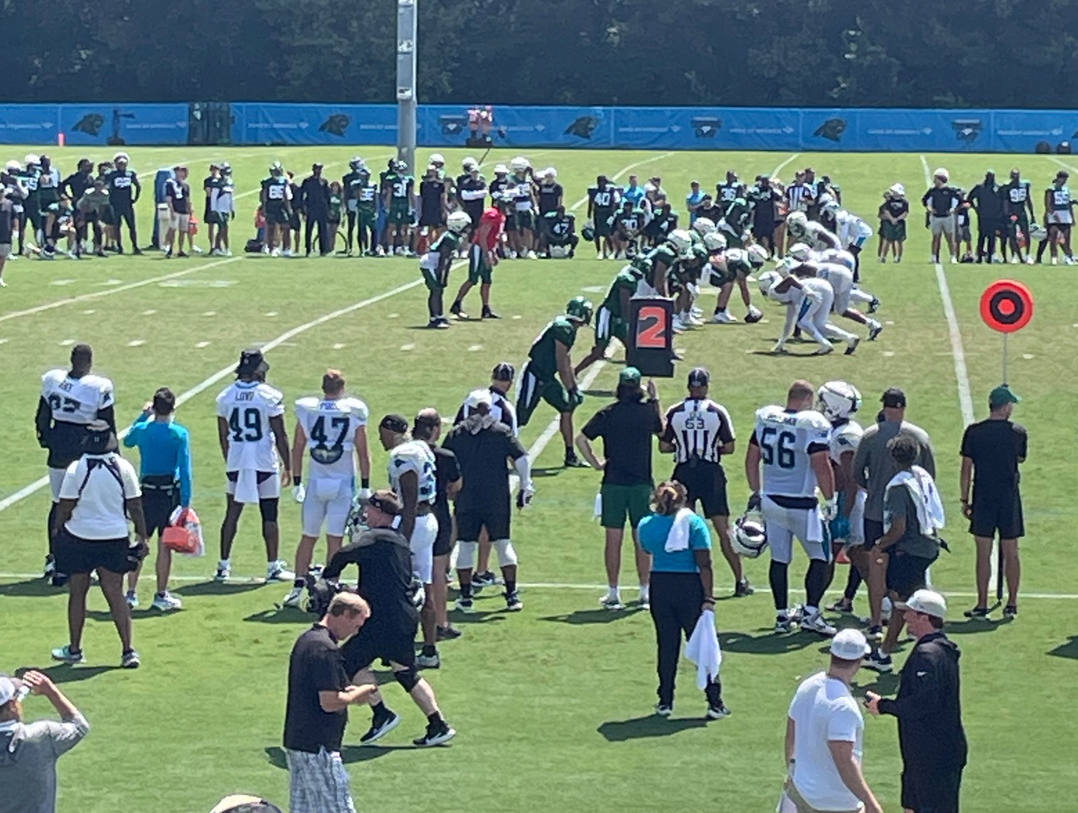Waiting eagerly for the snap, the Jets and Panthers get set to compete in the practice. 