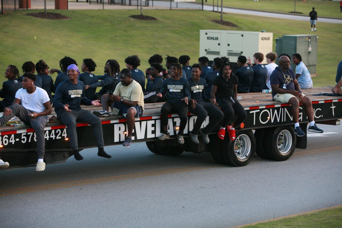 The Varsity Football team has fun while riding on a semi-truck.