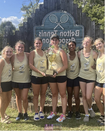 Proudly smiling at the camera, the varsity girl’s tennis team wins the Belton Classic, holding the first place trophy.