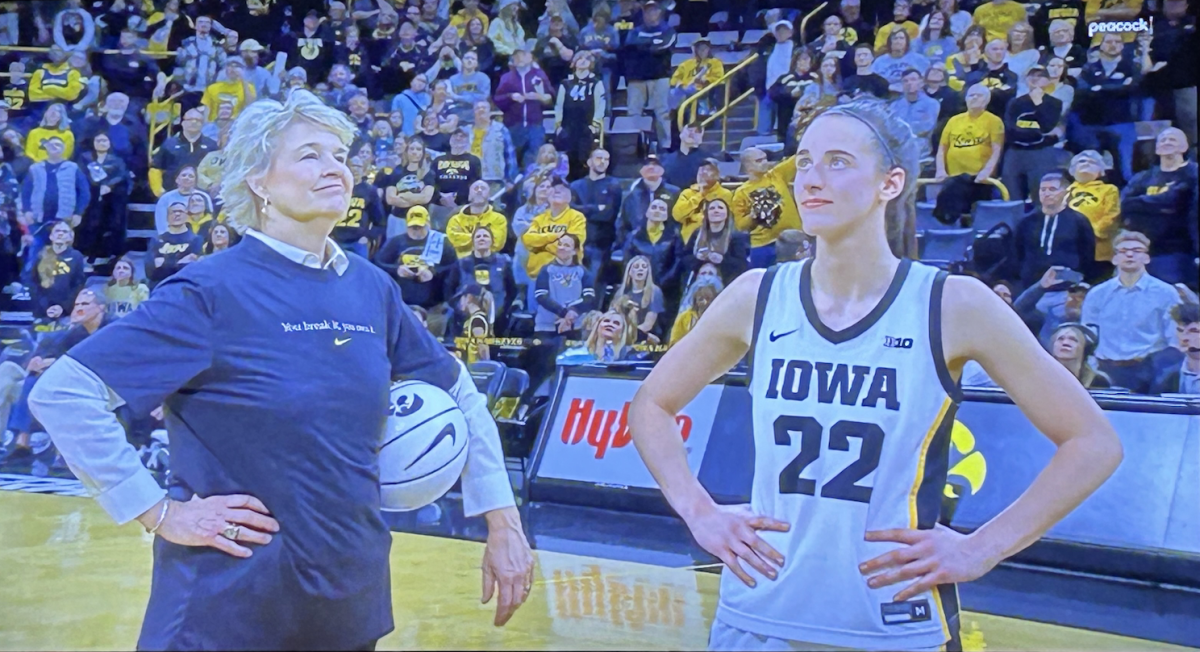 During+a+television+broadcast%2C+Caitlin+Clark+and+Coach+Lisa+Bluder+pose+for+a+photo+after+Clark+beat+the+NCAA+womens+career+scoring+record.