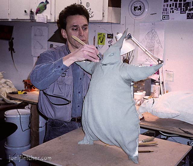 An artist works on the clay sculpture of Oogie Boogie from "The Nightmare Before Christmas."