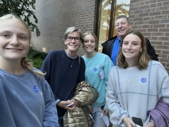 Caroline Byers (12) takes a celebratory picture with her family after voting for the first time.