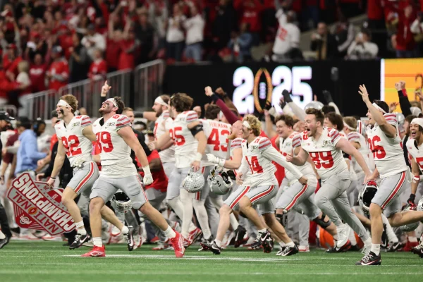 Ohio State players rush the field after winning the 2024-25 College Football Championship.