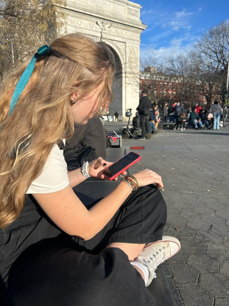 Faith Smith (11) checks social media on her phone while in New York City. 