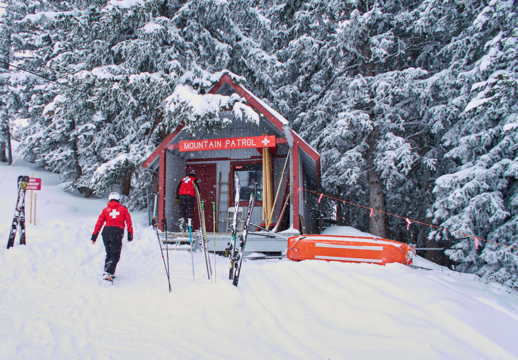 Members of the Ski Patrol in Park City walking in the Mountain Patrol Station Hut.