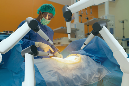 Doctor using a robot to perform a surgery on a patient.