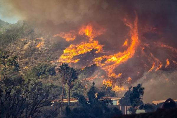 Flames coming over the hills of Los Angeles burning everything in its path.