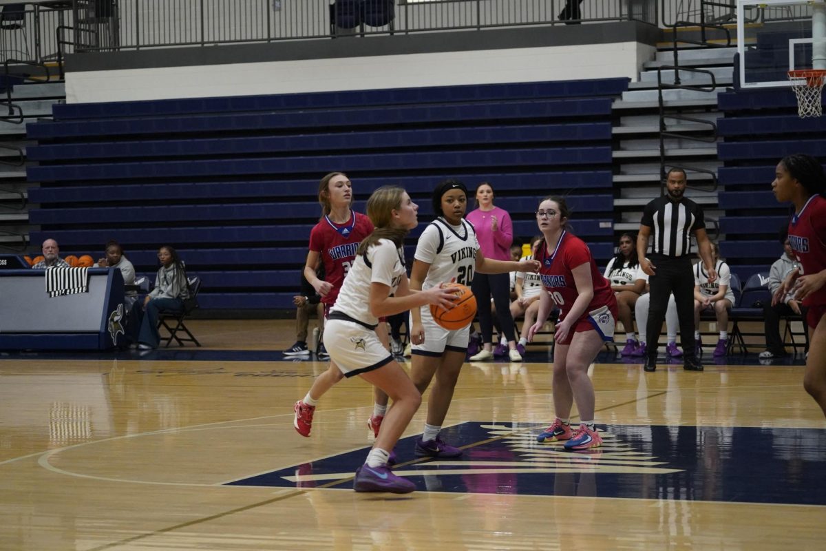 Anna Evans (10) prepares to shoot a basket to help her team win against the Riverside High School Warriors.