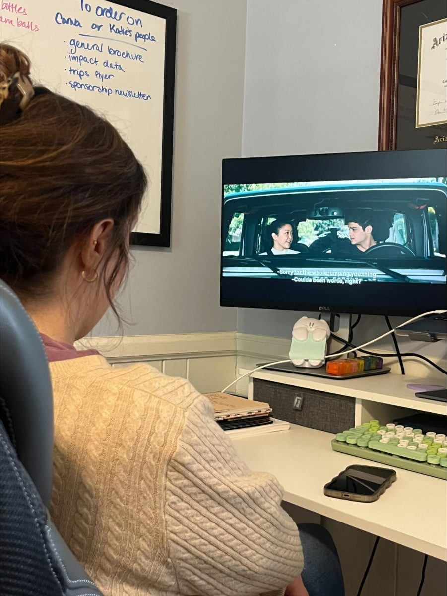 A fan of romantic comedies enjoying "To All the Boys I've Loved Before."