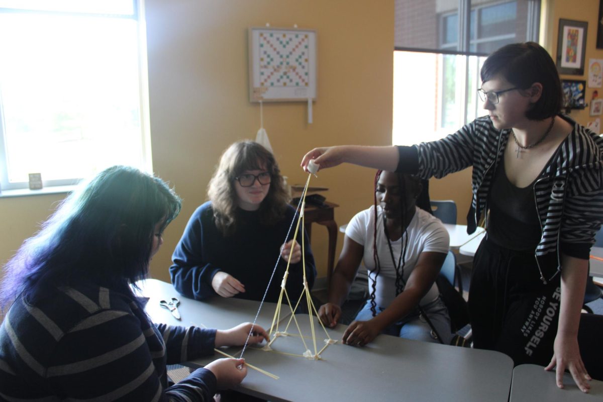 With precision and attention to detail, students work together on a project in Alison Little's Psychology class.