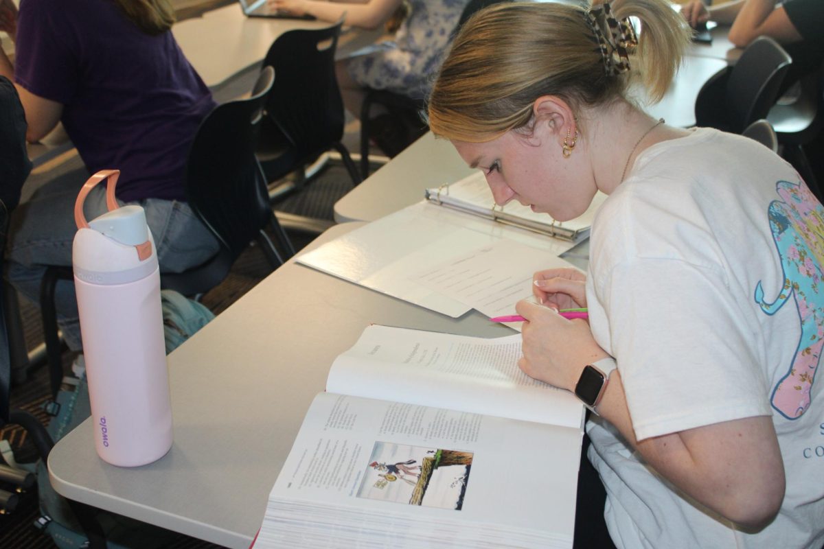 Making sure to answer all questions, Emma Shaw (11) works on an assignment for class.