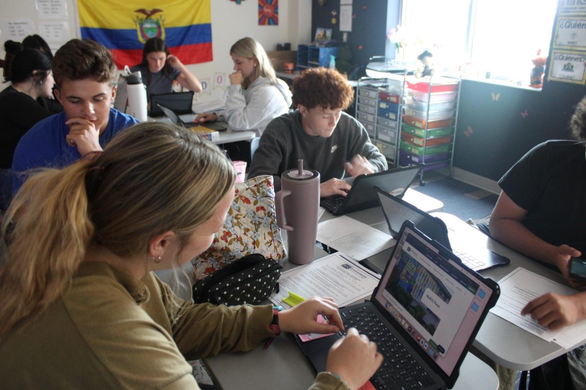 During the first week of school, Harper Wilson (12), Charlie McCrory (10) and Behr Hutson (12) work on their application for dual enrollment classes.