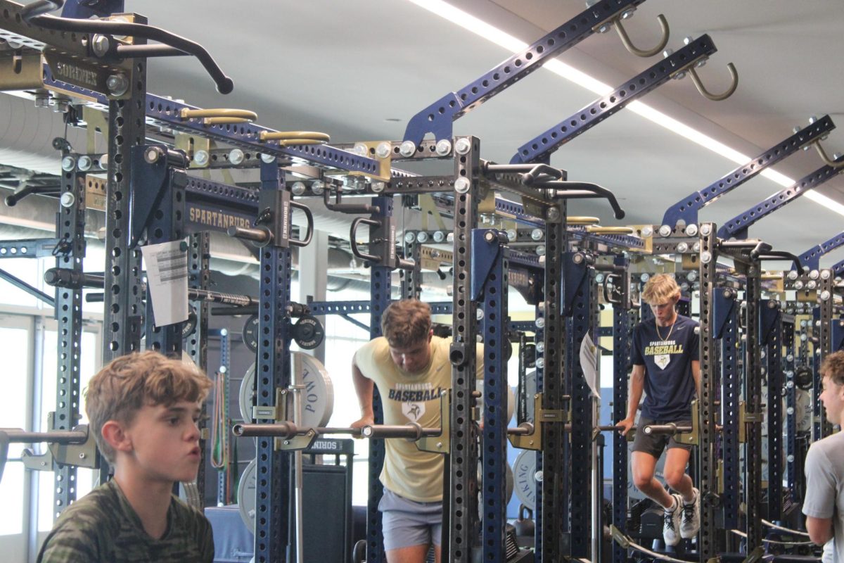 Viking athletes, Charlie McCory (10), Unknown (?) and Unknown (?) preparing for an upcoming season of baseball this spring.