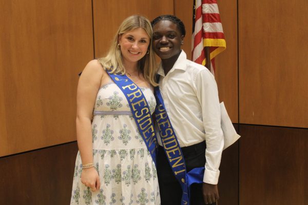 Reese Crocker (12) and Javian Smith (12) take a photo together at Club Allegro to celebrate being the president and vice president in the choir program. Club Allegro is an annual choir performance that raises money for senior scholarships.
