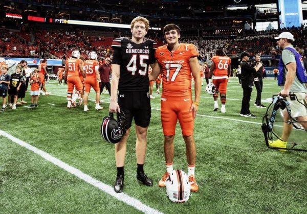 Spartanburg High alumni William Joyce and John Love reunite proudly, representing South Carolina and Virginia Tech on the national stage.